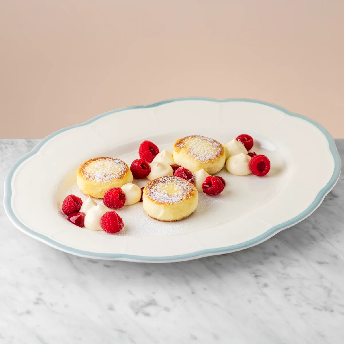 Syrniki with mascarpone and raspberries
